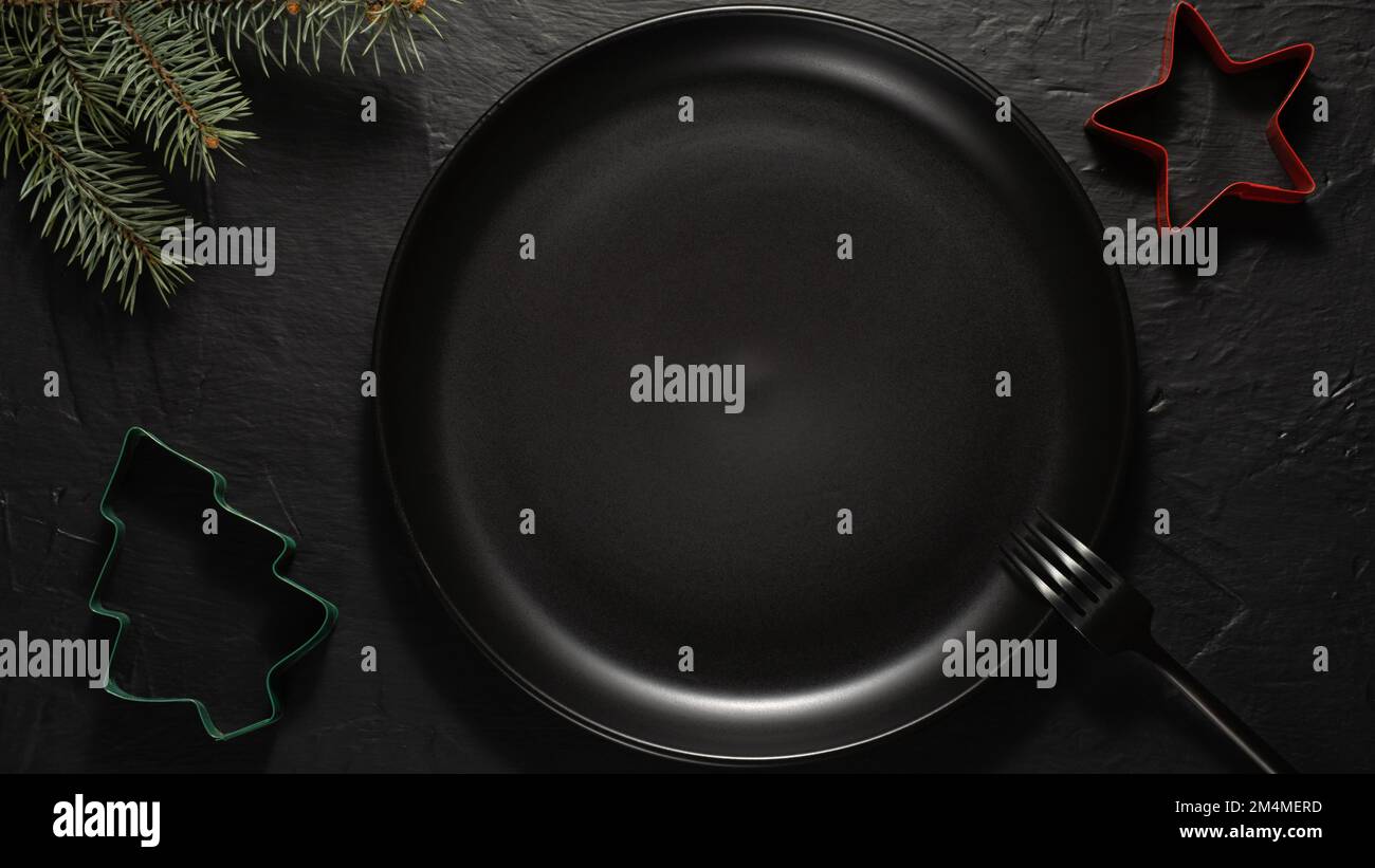 Table de Noël avec plaque en céramique noire vide, branche de sapin Banque D'Images Table de Noël avec plaque en céramique noire vide, branche de sapin Banque D'Images