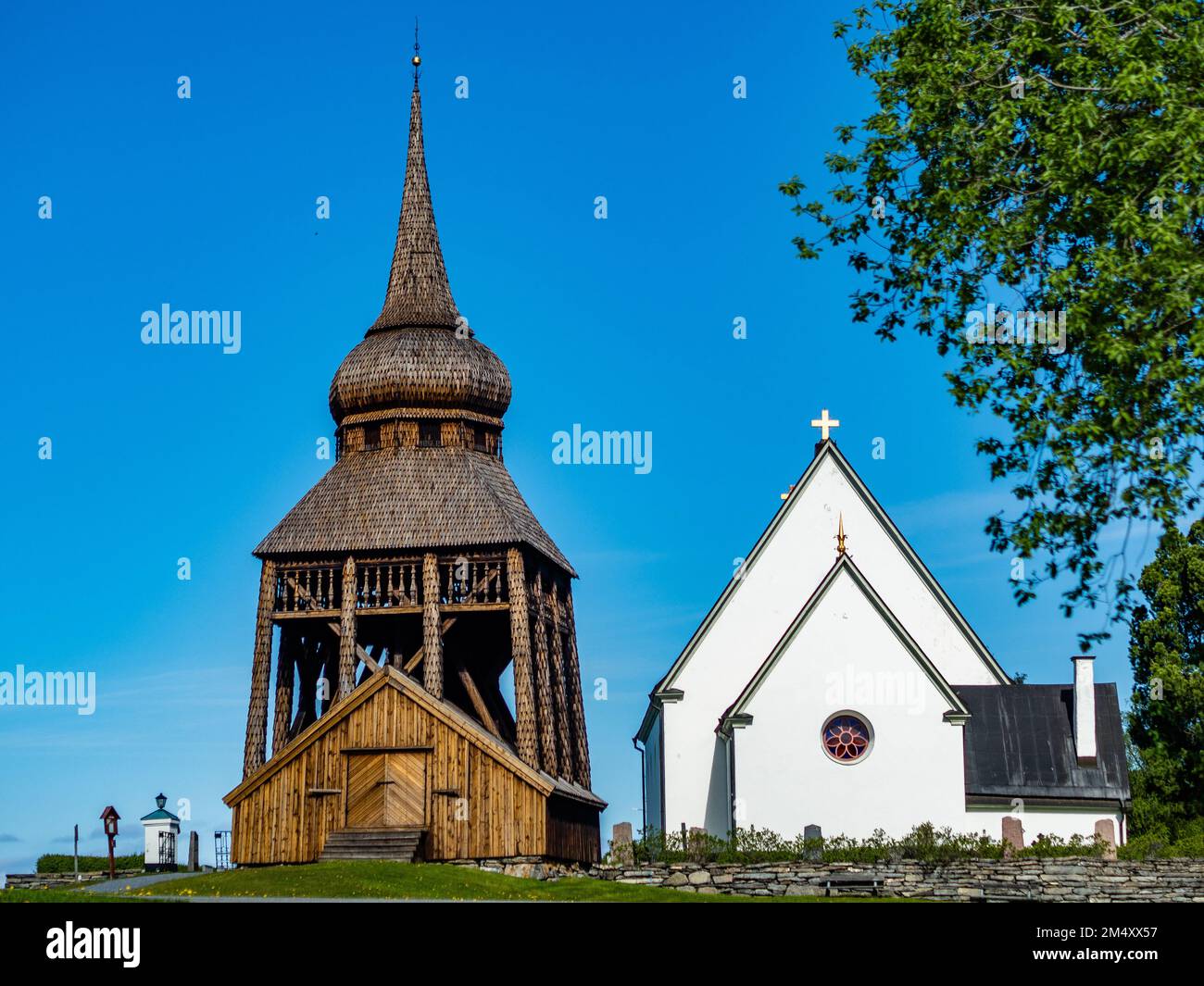 Un pèlerin se trouve à la porte d'entrée de l'une des principales attractions touristiques de Jämtland, l'église Frösö en Suède. Il peut être daté du douzième ou 12th siècle. Le clocher attrayant et caractéristique, qui se dresse séparément de l'église, a été construit au 18th siècle. C'est l'une des églises les plus photographiées le long du sentier. Le pèlerinage scandinave est connu sous le nom De 'st. Olavsleden', est une route 580km qui va de la mer Baltique à l'est à l'océan Atlantique à l'ouest, de Selånger en Suède à Trondheim en Norvège. Banque D'Images