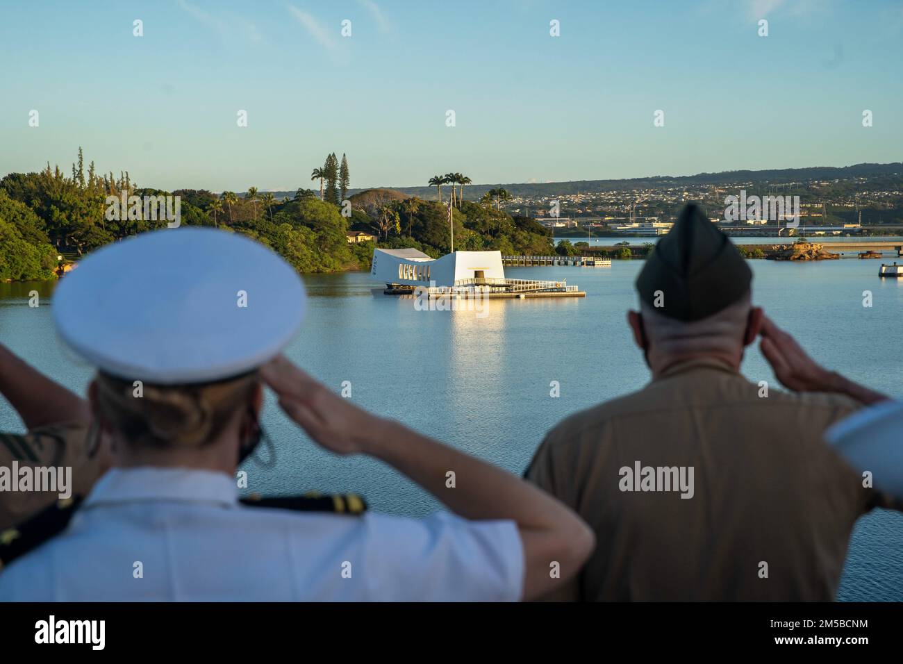 PEARL HARBOR, Hawaii (19 février 2022) Marines et marins affectés à l'unité expéditionnaire maritime (MEU) de 11th et au quai de transport amphibie USS Portland (LPD 27) saluent le mémorial de l'USS Arizona pendant que portland se rend sur les rails à Pearl Harbor, Hawaï, 19 février. Marines et marins du Essex Amphiobie Ready Group (ARG) et du MEU 11th visitent la base conjointe Pearl Harbor-Hickam tout en opérant dans la flotte US 3rd. Banque D'Images