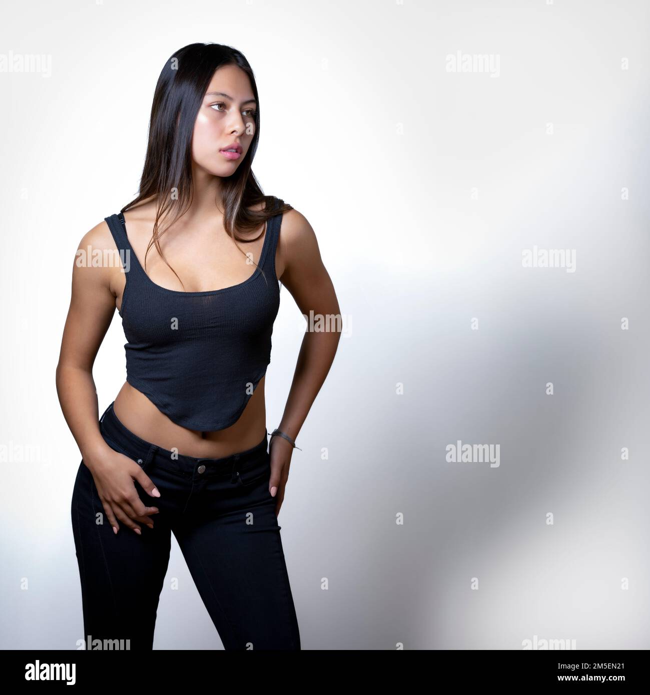 Teen féminine multiraciale edgy debout devant un arrière-plan blanc | espace de copie Banque D'Images