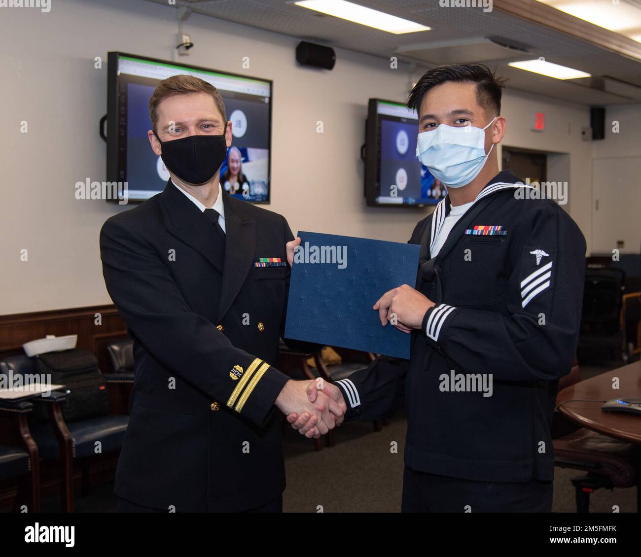 Hospitalman Eukhy Sta Ana, affecté aux États-Unis Hôpital naval clinique de santé de la branche de Yokosuka Sasebo pose pour une photo avec le lieutenant Jonathan Wilberscheid lors d'une cérémonie de naturalisation au commandant, activités de la flotte Sasebo 14 mars 2022. ÉTATS-UNIS Les Services de citoyenneté et d'immigration et le Bureau des services juridiques de la région du Pacifique occidental ont collaboré à la cérémonie de naturalisation au CFAS, permettant aux deux marins de devenir citoyens américains. Banque D'Images