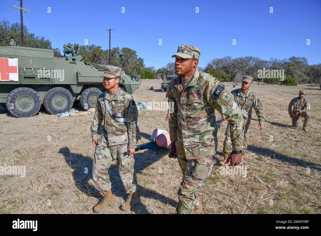 Lors de la mise en place et de la validation de la voie d'évacuation médicale, le sergent d'état-major Caleb Stinson (arrière droit) supervise des soldats de formation individuelle avancée détaillée qui déplacent une victime simulée dans une ambulance de champ avant le début de l'épreuve de test de badge médical sur le terrain MEDCoE au Camp Bullis, au Texas. Banque D'Images