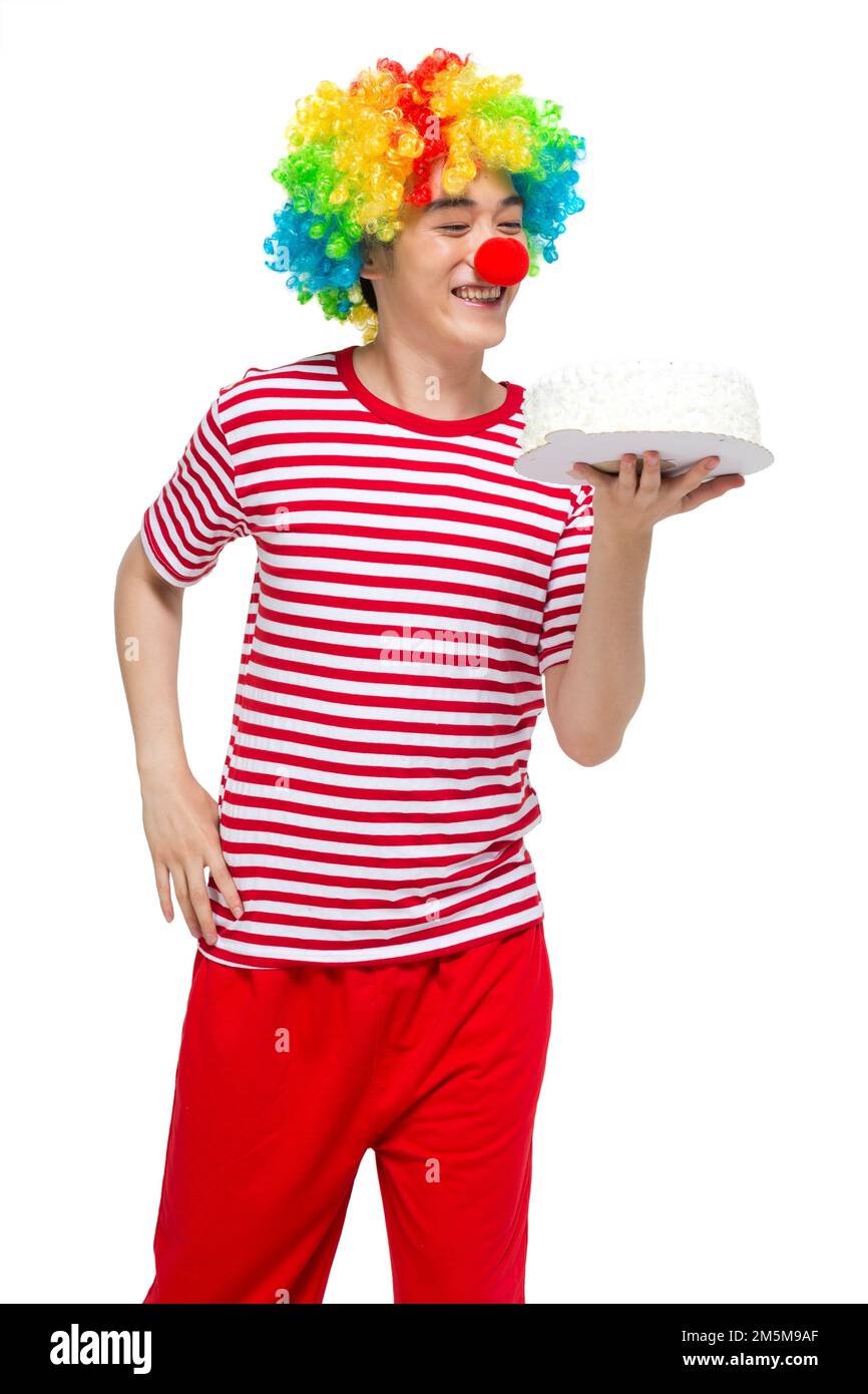 Verser le clown amusant heureux, avec le gâteau Banque D'Images