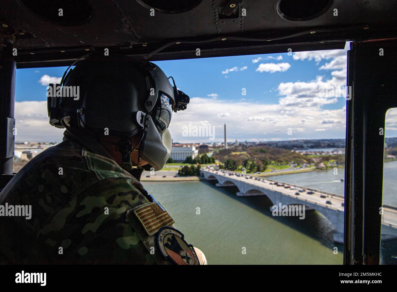 Le Sgt technique de la Force aérienne Ivan Dotimas, premier Escadron d’hélicoptères (1 HS), AVIATEUR de mission spéciale UH-1N, surplombe le pont commémoratif d’Arlington à Washington, D.C., 26 mars 2022. La mission du SH 1 est de fournir un service de transport aérien prioritaire pour les cadres supérieurs civils et militaires de niveau national dans la région de la capitale nationale. Banque D'Images