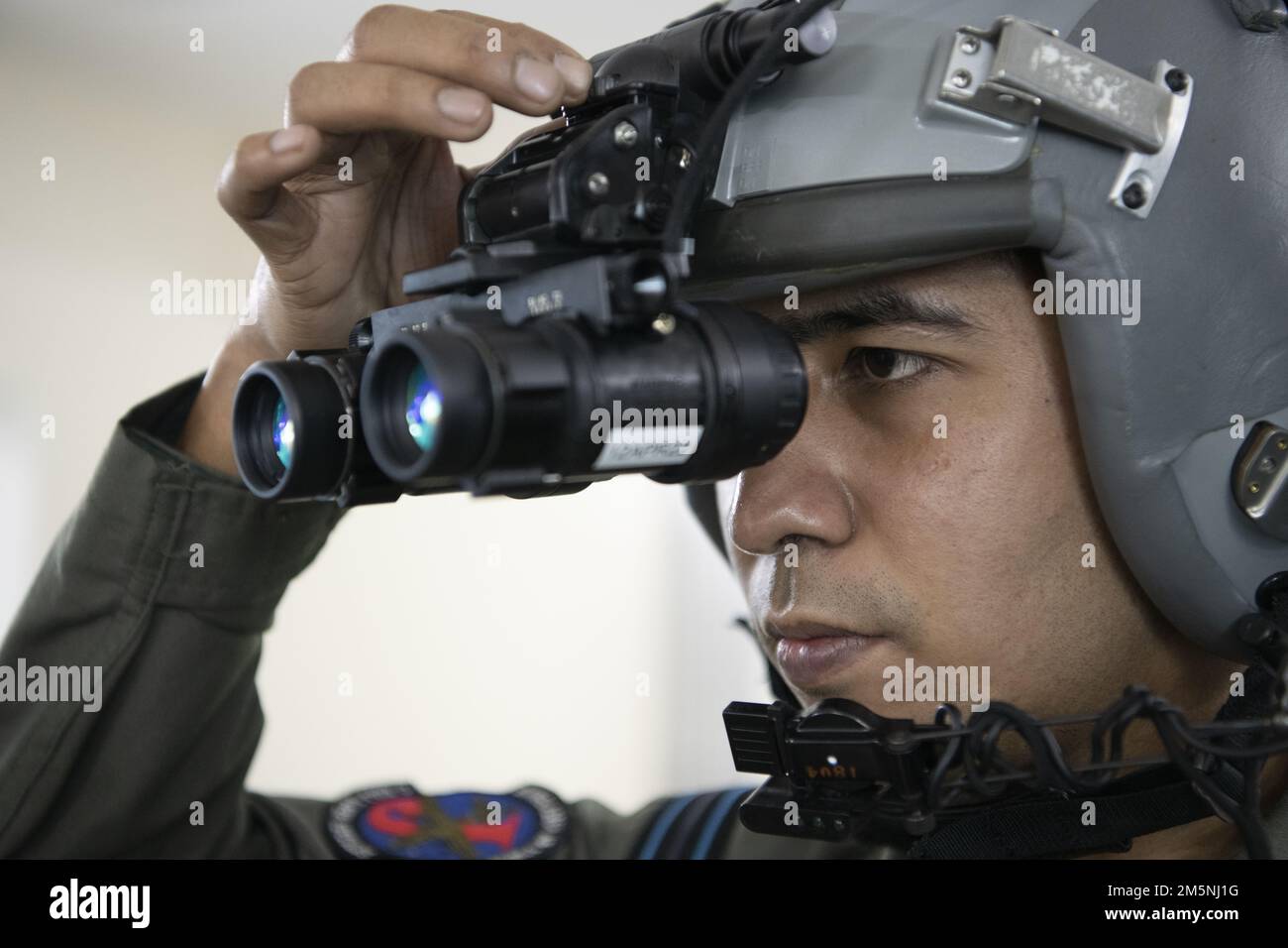 Le pilote de la Force aérienne du Bangladesh (BAF) C-130, le lieutenant de vol Araf Billah, ajuste les lunettes de vision nocturne en vue d'une sortie de nuit pendant l'exercice COPE Sud 2022, le 24 février 2022, à la base BAF Bangabandhu (Bangladesh). ÉTATS-UNIS Les pilotes de la Force aérienne et de la BAF ont échangé des techniques pour voler dans des conditions de faible éclairage dans le cadre de l'exercice. L’exercice Cope South est un exercice de transport aérien tactique bilatéral bi-annuel parrainé par les forces aériennes du Pacifique, destiné à améliorer la capacité des forces américaines et du Bangladesh à opérer ensemble. Banque D'Images