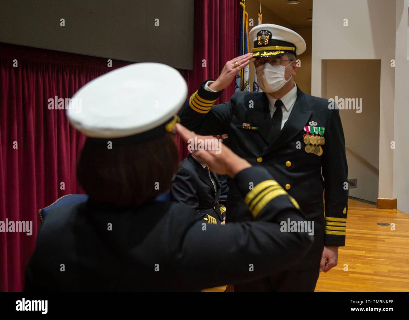 220225-N-XB470-1216 SAN DIEGO (25 février 2022) le Capt John Lyszczarz (retraité), un marin affecté au Commandement de la préparation et de l'entraînement en médecine navale (NMRTC) San Diego (à droite), rend hommage lors de sa cérémonie de retraite dans l'auditorium de l'hôpital le 25 février. Lyszczarz a servi dans la Marine pendant plus de 32 ans, et a terminé sa carrière en tant que directeur du programme de résidence psychiatrique de NMRTC à San Diego. La mission du NMRTC de San Diego est de préparer les membres du service à se déployer à l'appui des forces opérationnelles, à fournir des services de santé de haute qualité et à façonner l'avenir de la médecine militaire par l'éducation, la formation an Banque D'Images 220225-N-XB470-1216 SAN DIEGO (25 février 2022) le Capt John Lyszczarz (retraité), un marin affecté au Commandement de la préparation et de l'entraînement en médecine navale (NMRTC) San Diego (à droite), rend hommage lors de sa cérémonie de retraite dans l'auditorium de l'hôpital le 25 février. Lyszczarz a servi dans la Marine pendant plus de 32 ans, et a terminé sa carrière en tant que directeur du programme de résidence psychiatrique de NMRTC à San Diego. La mission du NMRTC de San Diego est de préparer les membres du service à se déployer à l'appui des forces opérationnelles, à fournir des services de santé de haute qualité et à façonner l'avenir de la médecine militaire par l'éducation, la formation an Banque D'Images