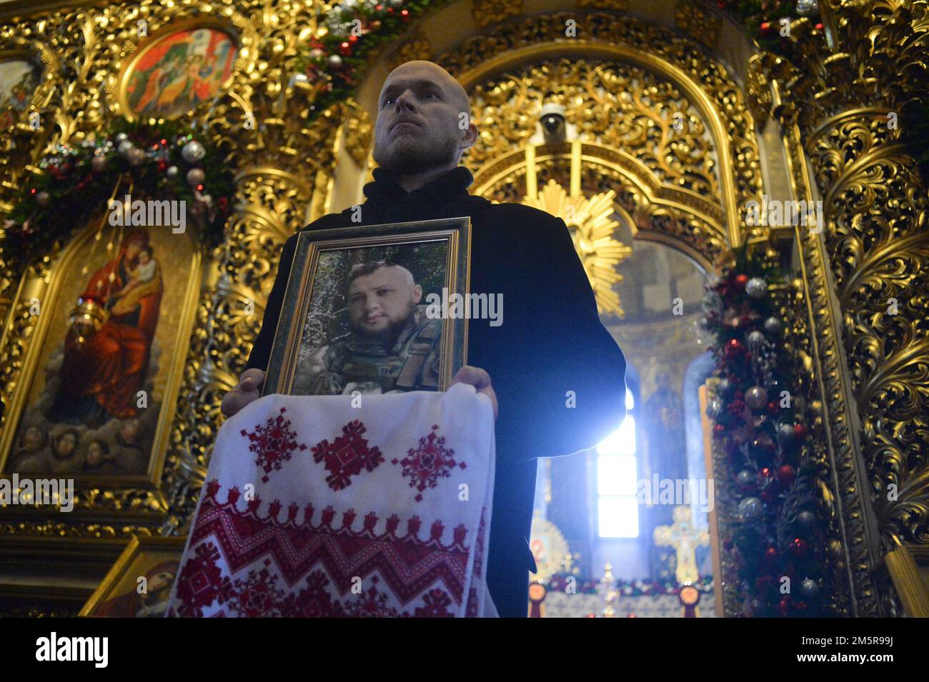 KIEV, UKRAINE - 30 DÉCEMBRE 2022 - Un homme tient le portrait de l'ancien prisonnier politique Hennadii Afanasiev qui est mort sur la ligne de front pendant le plaisir Banque D'Images