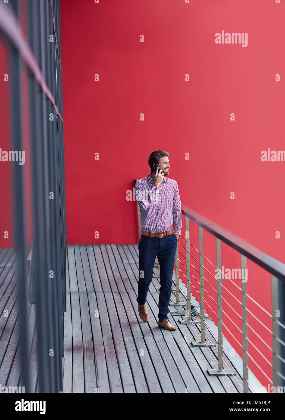 Pour plus d'intimité sur le balcon. un jeune homme d'affaires parlant au téléphone sur le balcon d'un bureau. Banque D'Images