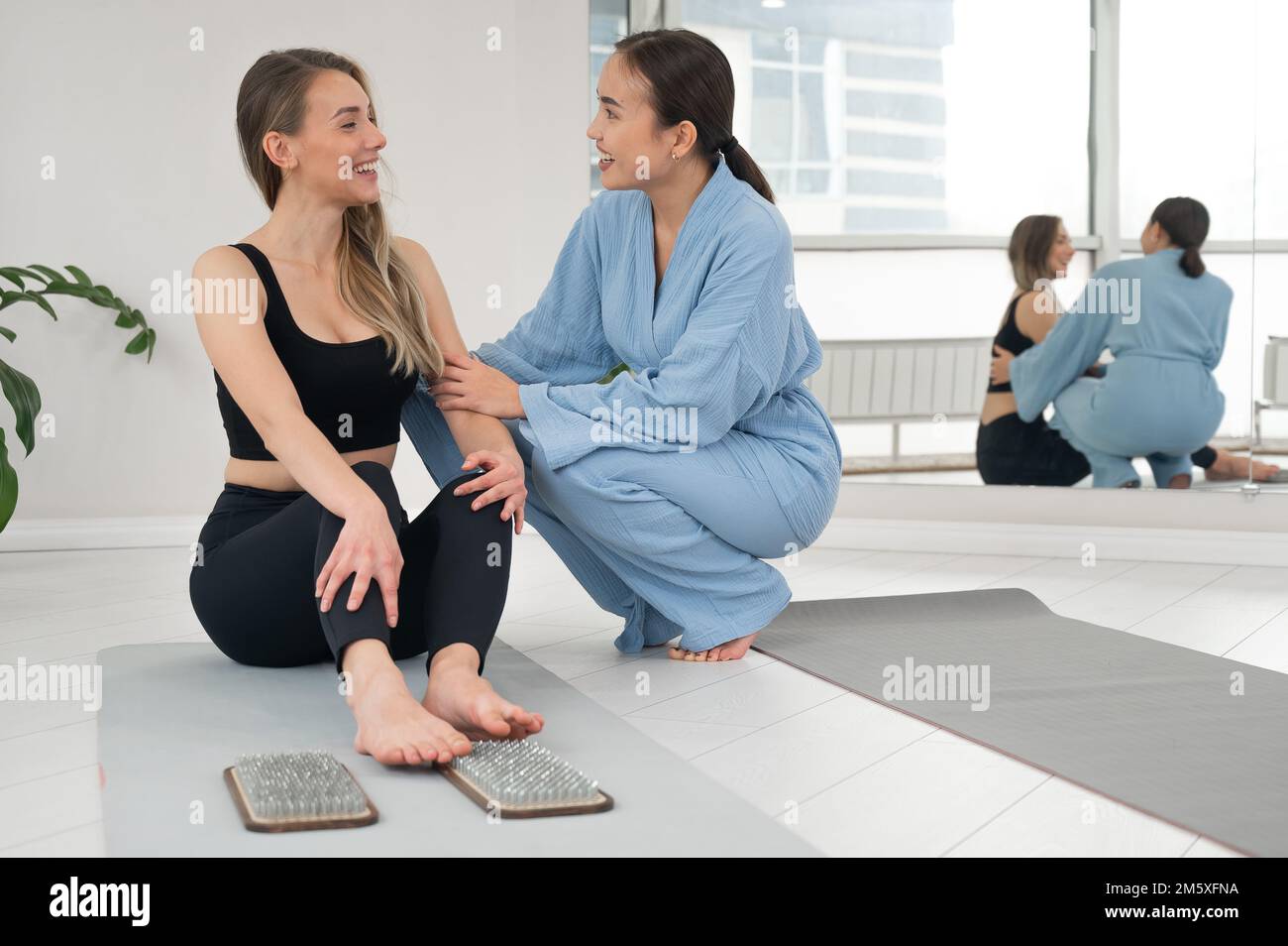 Le thérapeute soutient le client après s'être debout sur les planches de sadhu. Pratique du clouage. Banque D'Images Le thérapeute soutient le client après s'être debout sur les planches de sadhu. Pratique du clouage. Banque D'Images
