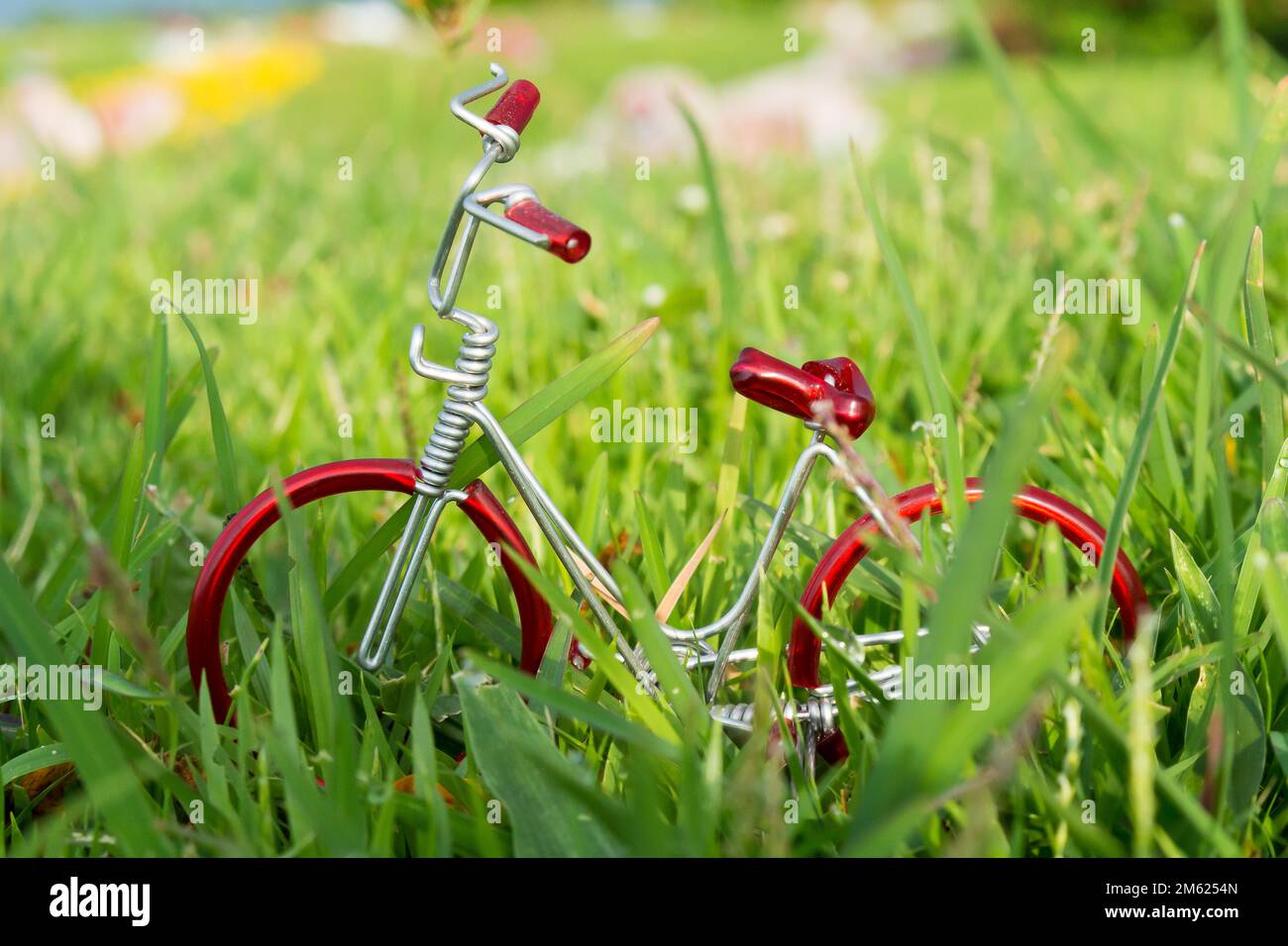 mini vélo jouet rouge sur l'herbe. Banque D'Images