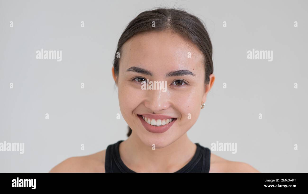 Portrait d'une femme asiatique souriante sur fond blanc. Banque D'Images Portrait d'une femme asiatique souriante sur fond blanc. Banque D'Images