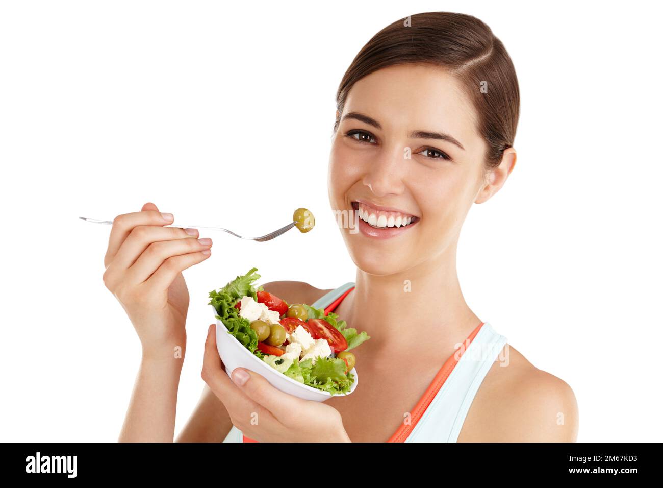 Ce que vous mangez en privé, vous portez en public. Femme sur fond blanc prête à manger de la salade. Banque D'Images