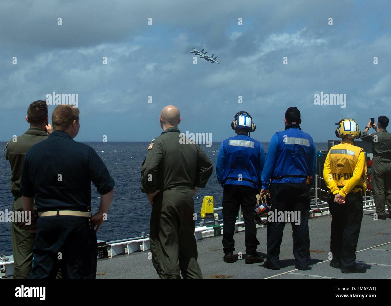 Des marins à bord de l'USS Gerald R. Ford (CVN 78) observent le commandant de la Carrier Air Wing 8, le capitaine Daryl Trent, TOP, et Cmdr. Andrew Thom, commandant à venir des « loups gris » de l'escadron d'attaque électronique (VAQ) 142, lors d'une cérémonie de passation de commandement de la VAQ-142, 14 avril 2022. Thom, de Yorktown, Virginie, soulagé Cmdr. Andrew Imperatore pendant le changement de commandement aérien. Ford est en cours dans l’océan Atlantique en menant des qualifications de transporteur et l’intégration du groupe de grève dans le cadre de la phase de base sur mesure du navire avant le déploiement opérationnel. Banque D'Images