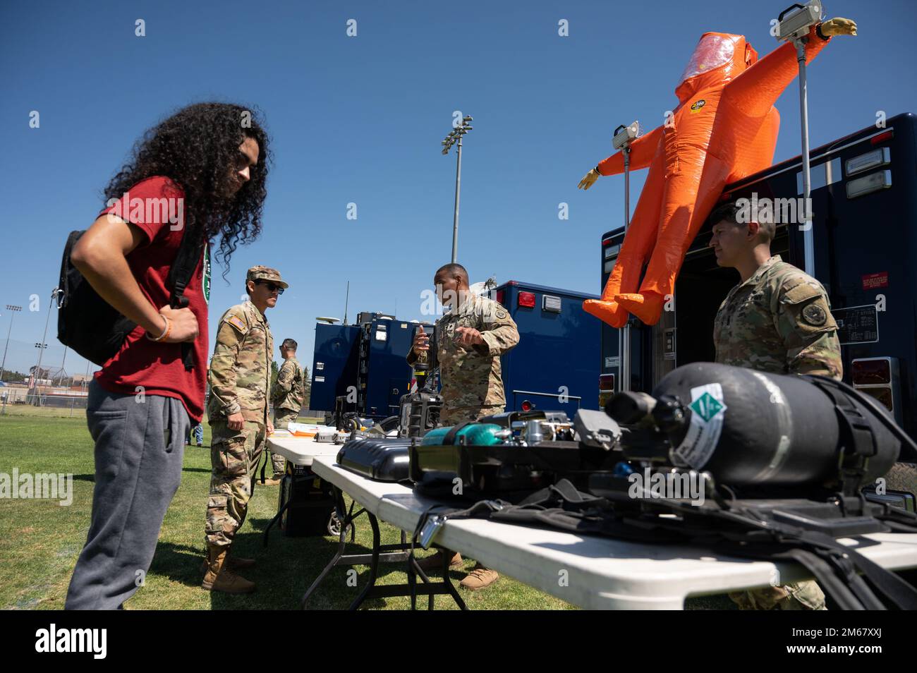 ÉTATS-UNIS Armée 1st Lt. Demetrious Pitsikos, à droite, chef d’équipe d’enquête auprès de l’équipe de soutien civil (armes de destruction massive) de la Garde nationale de Californie en 9th, Andrew Meddley, membre de l’équipe du SPC, au centre, discute avec un étudiant sur le campus de l’Université d’État de Californie, Fullerton, lors de la journée d’exposition militaire du collège, à 14 avril 2022, à Fullerton, en Californie. L’événement a été organisé par le programme ROTC de l’école et a offert aux cadets et aux élèves l’occasion d’en apprendre davantage sur les façons de servir à la Garde nationale et aux États-Unis Réserve de l'armée. Banque D'Images