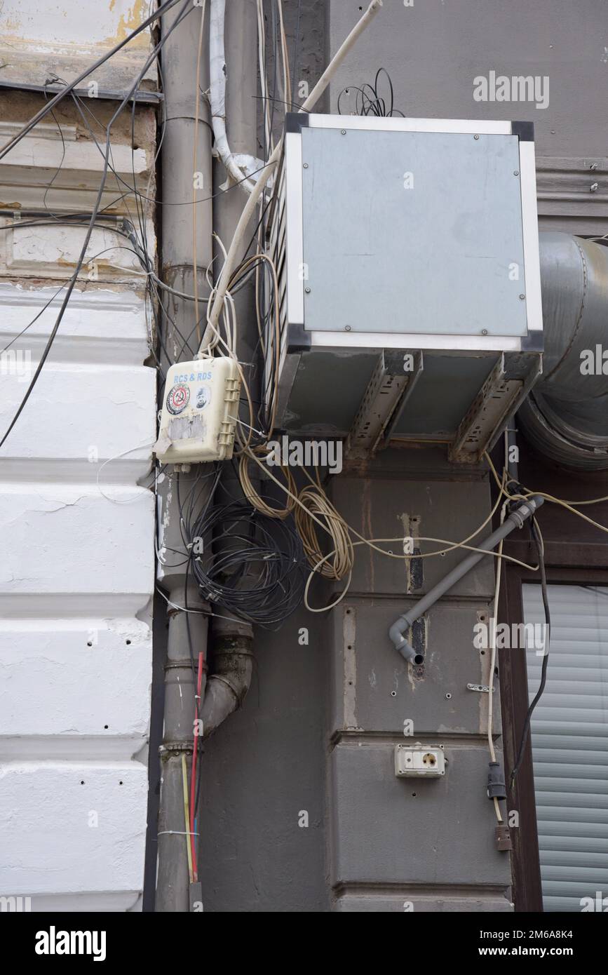 Un agencement désordonné de câbles haut débit pour téléphone et Internet dans la rue de Bucarest, Roumanie Banque D'Images
