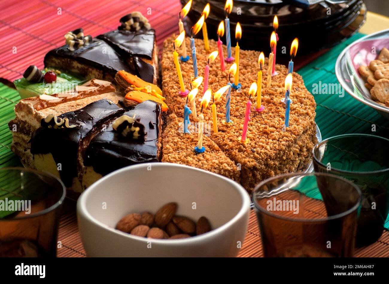 Divers morceaux de gâteau avec bougies allumées Banque D'Images