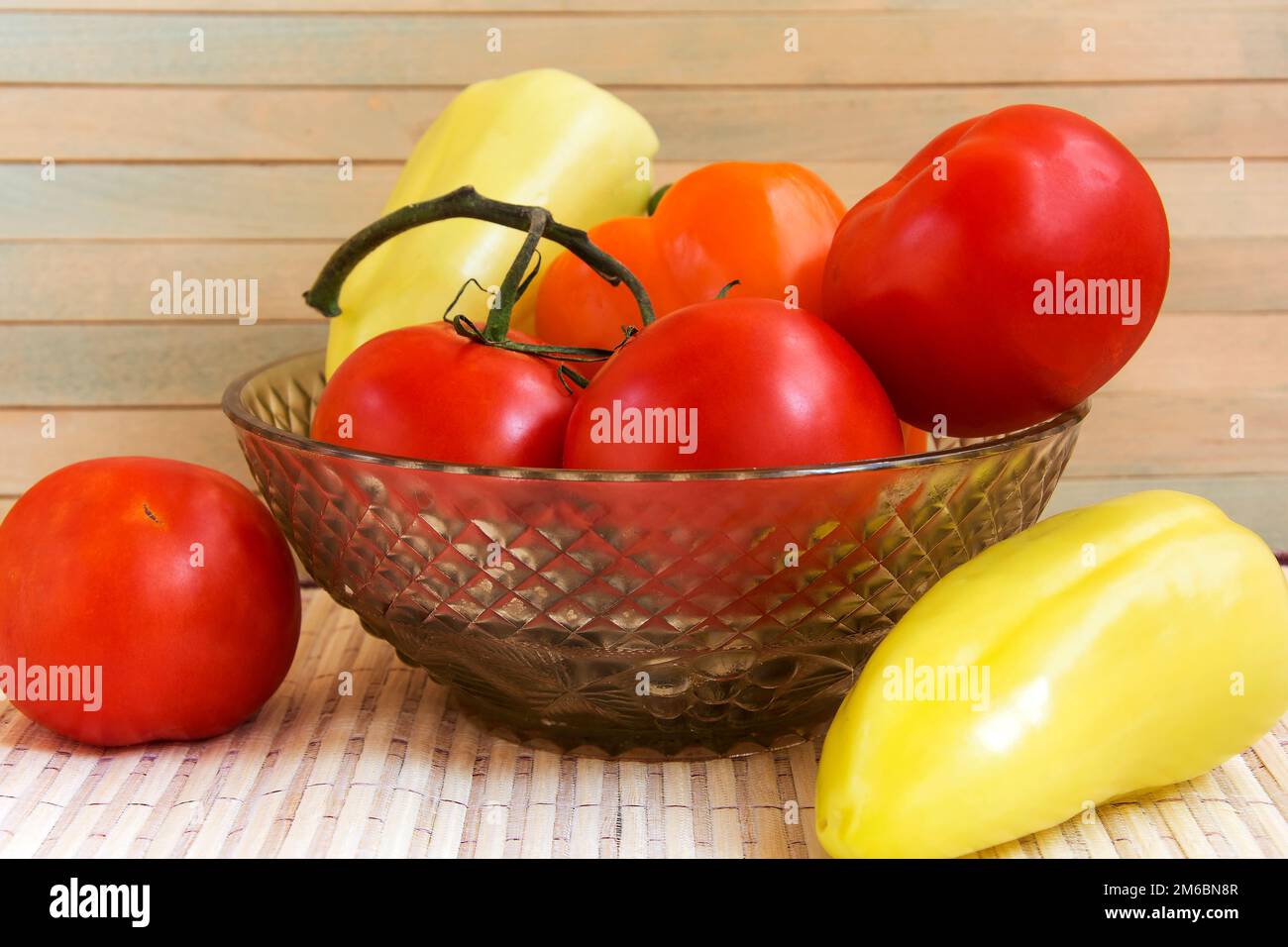 Légumes d'automne dans un vase en verre sur la surface en bois clair Banque D'Images