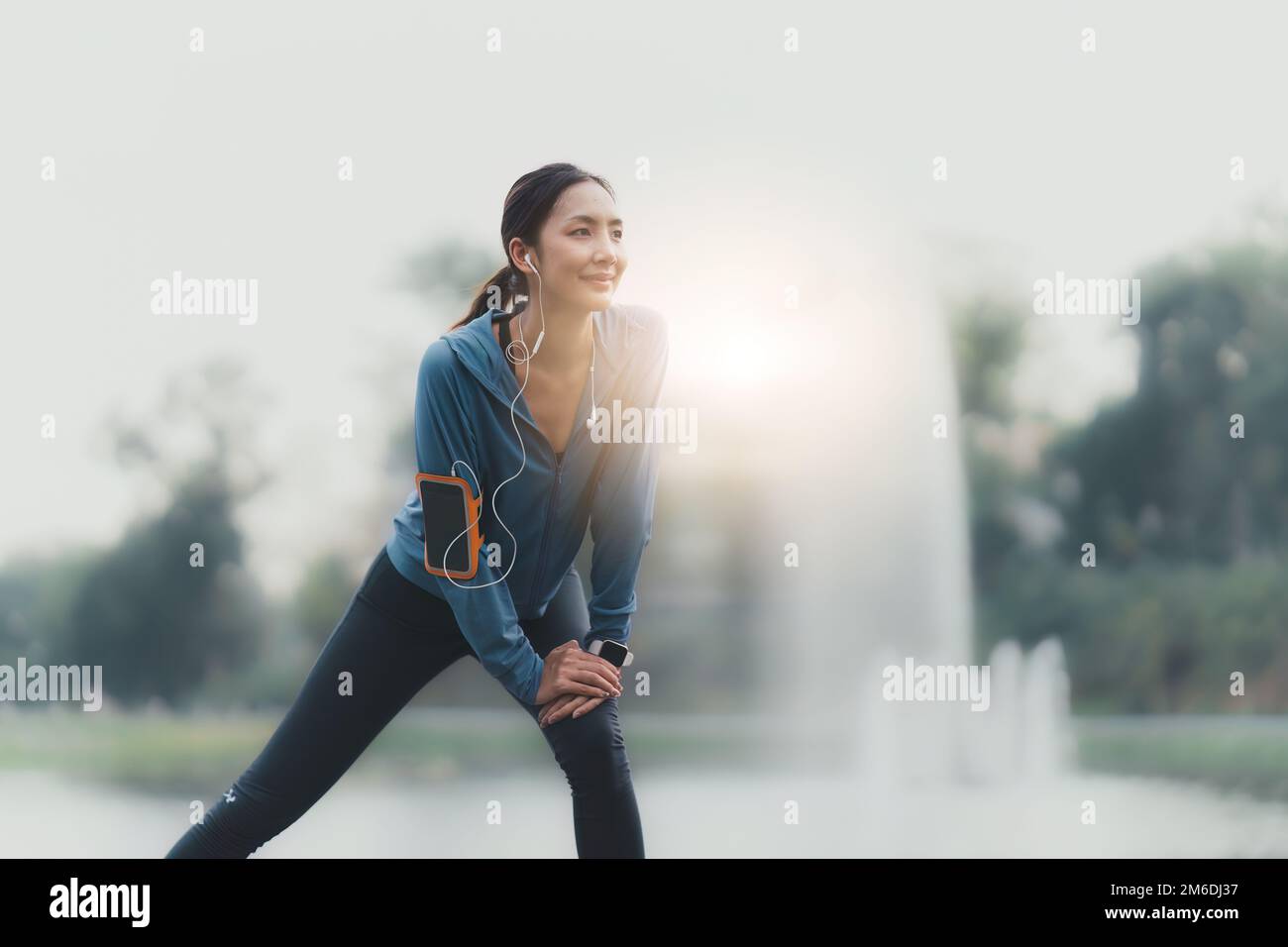Une femme asiatique en bonne santé fait du jogging en plein air. Fitness fille courant. Une femme fait de l'exercice dans un parc extérieur Banque D'Images