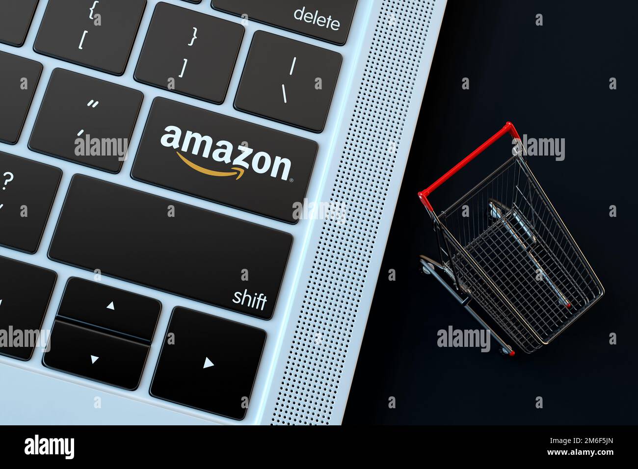 Logo Amazon sur le clavier de l'ordinateur portable et le panier miniature. 3D rendu Banque D'Images