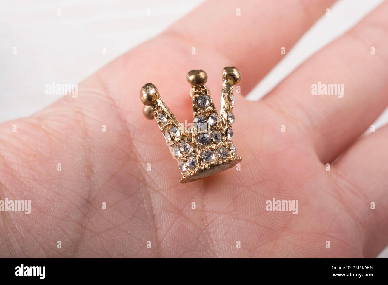La petite couronne du modèle est placée à la main Banque D'Images