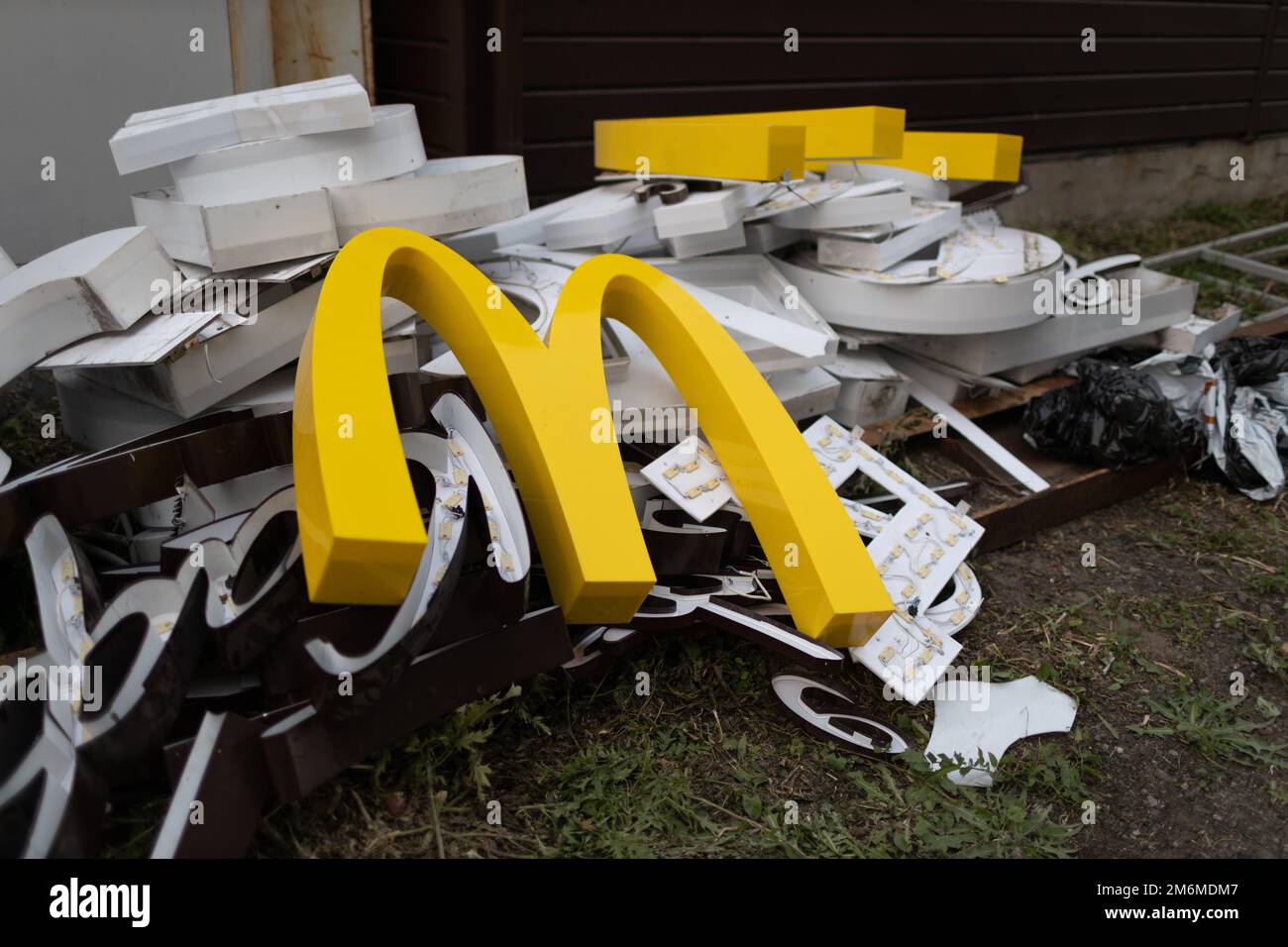 Moscou, Russie - 06.21.2022: McDonald's logo lettre caractère M sur sale tas de déchets vider déchets déchets déchets. Restauration rapide et sa Banque D'Images