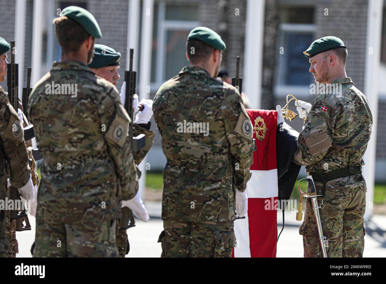Les soldats danois défurent le drapeau de leur nation dans le cadre de la cérémonie d'accueil des troupes danoises sur le terrain de parade du site d'opération Forward Adazi, Lettonie, 06 mai 2022. Des soldats danois ont été reçus lors d’une cérémonie de bienvenue, dans le cadre de la présence avancée renforcée de l’OTAN en Lettonie, renforçant ainsi les liens au sein de l’alliance. Banque D'Images