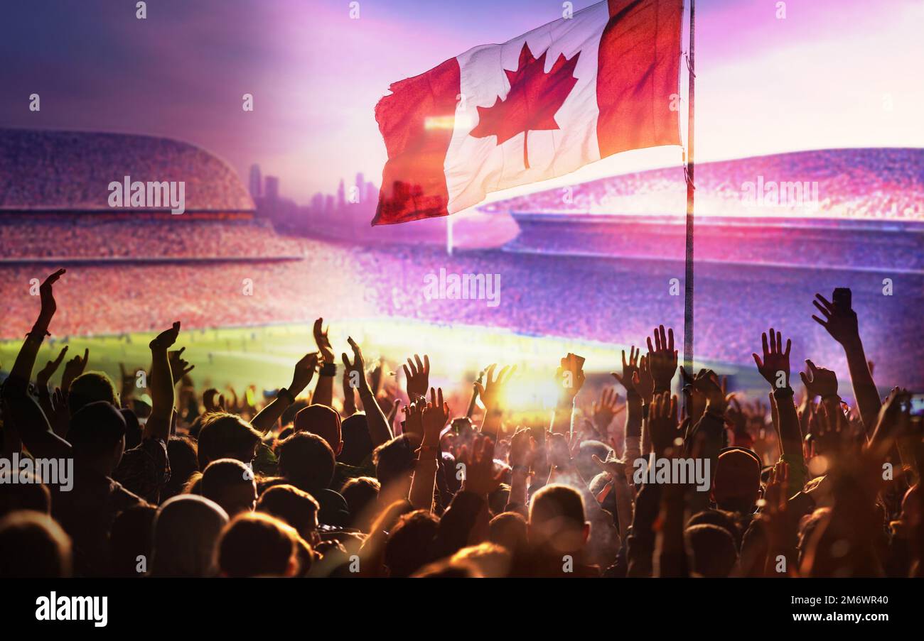 Les fans de football ou de soccer et le drapeau du Canada à un match dans un stade Banque D'Images