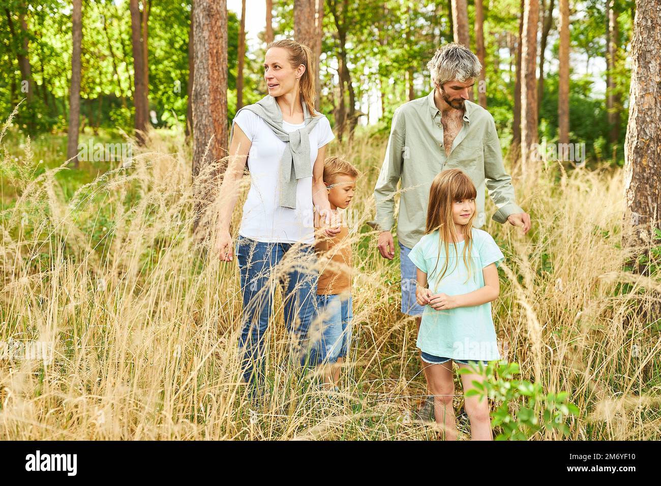 Randonnée en famille avec son fils et sa fille dans la nature et exploration de la forêt pendant les vacances d'été Banque D'Images