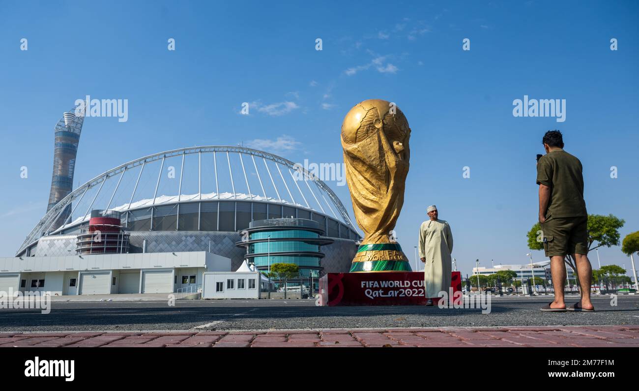 Doha, Qatar. 08th janvier 2023. Un homme prend une photo d'un trophée de la coupe du monde de la FIFA qui se tient devant le stade Khalifa dans la ville désertique. Le FC Bayern Munich termine son camp d'entraînement d'hiver à Doha (Qatar) jusqu'en 12.01.2023. Credit: Peter Kneffel/dpa/Alay Live News Banque D'Images