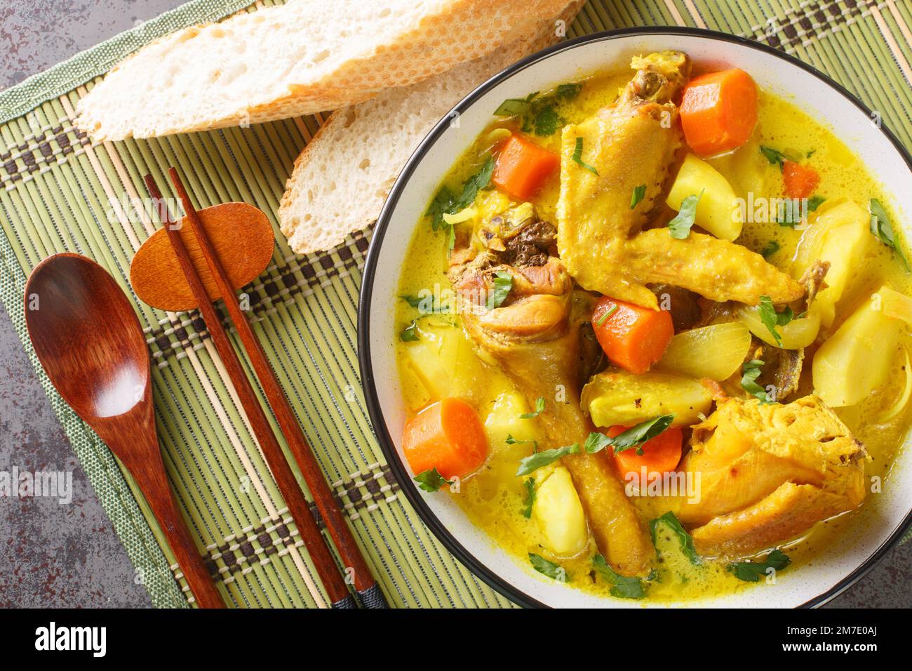 CA ri ga est un curry de poulet vietnamien délicieusement parfumé mais doux, imprégné d'herbes fraîches et d'épices dans une assiette sur la table. Horizontale Banque D'Images