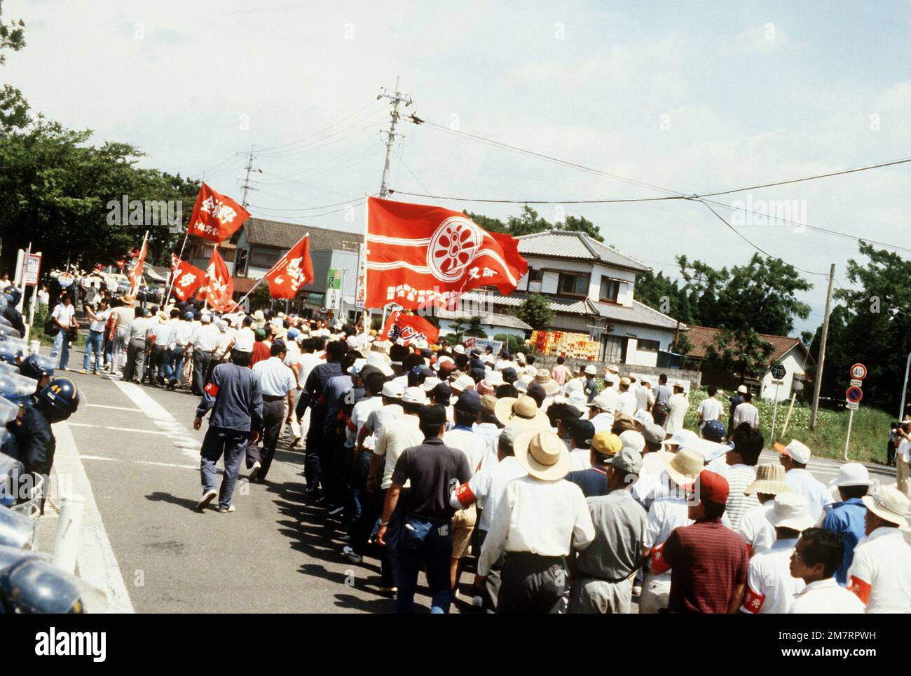 La police de sécurité ligne la rue à l'extérieur de la porte principale, alors que des groupes anti-militaires ont une manifestation pendant l'exercice Cope North '81-3. Objet opération/série: COPE NORTH '81-3 base: Nyutabaru Air base État: Kyashu pays: Japon (JPN) Banque D'Images