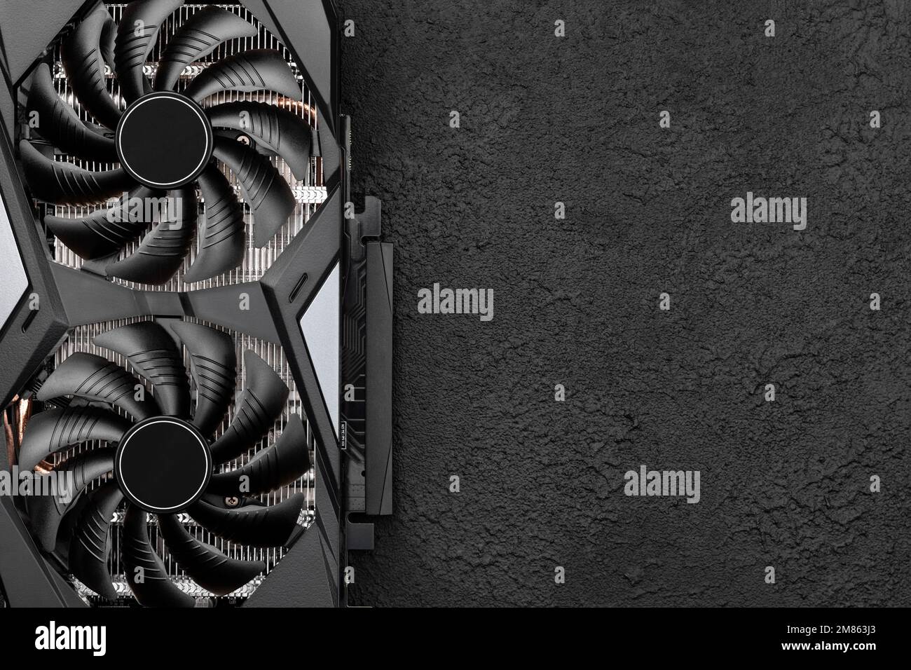 Carte graphique d'ordinateur, carte vidéo professionnelle avec deux ventilateurs sur fond de béton noir. Vue de dessus avec espace de copie Banque D'Images