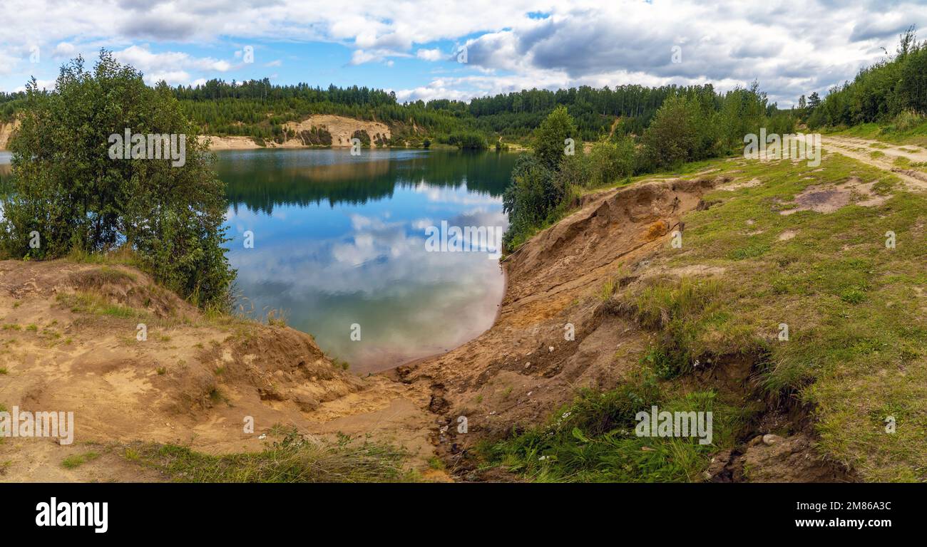 Neige - les nuages blancs sont reflétés dans le lac . Panorama Banque D'Images