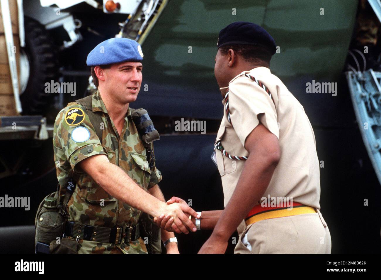 Le lieutenant-colonel kenyan Frank Mwangangi, adjoint militaire au commandant des forces générales du Groupe d'assistance à la transition des Nations Unies (GANUPT), accueille un membre du Royal Australian Engineers District. Le GANUPT effectuera des tâches de maintien de la paix et surveillera les élections de novembre 1989 et l'indépendance de la Namibie. Objet opération/série : CIRCONSCRIPTION ÉLECTORALE base : RAAF Richmond pays : Australie (AUS) Banque D'Images