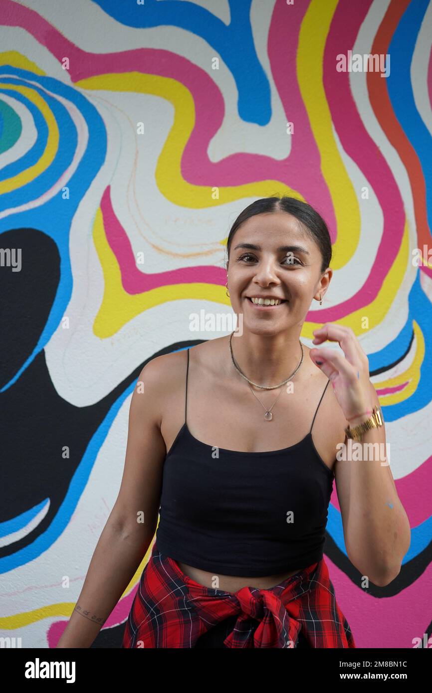 Peinture murale, belle femme peignant le mur coloré Banque D'Images