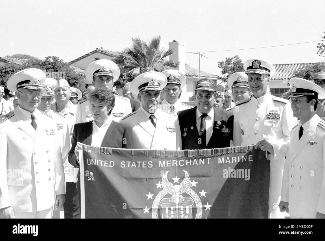 Après une cérémonie de pose de couronnes au cimetière national de fort Rosecrans pour honorer les marins américains morts lors de la livraison de fournitures à l'Union soviétique pendant la Seconde Guerre mondiale, Maureen O'Connor, maire de San Diego, deuxième de gauche; Gennadiy Khvatov, commandant de la flotte du Pacifique soviétique, troisième de gauche; États-Unis Le commandant de la flotte du Pacifique, l'ADM Charles R. Larson, deuxième de droite, et d'autres se rassemblent autour d'un américain Drapeau de la marine marchande. Trois navires de la flotte du Pacifique soviétique sont à San Diego pour une visite de bonne volonté de cinq jours. Base: San Diego État: Californie (CA) pays: Etats-Unis d'Amérique (USA) Banque D'Images