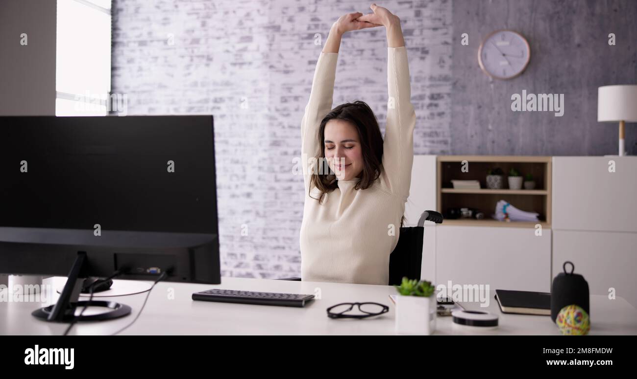 Exercice d'étirement des bras assis au bureau Banque D'Images