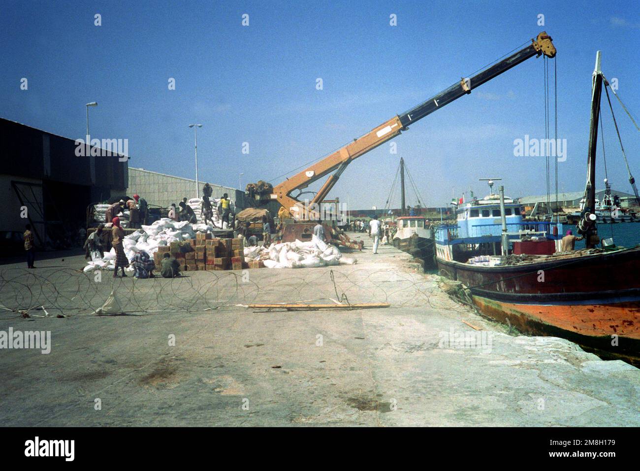 Une grue décharge les fournitures d'un bateau pendant les efforts de secours de l'opération Restore Hope. Objet opération/série: RÉTABLIR LA BASE DE L'ESPOIR: Mogadishu pays: Somalie (SOM) Banque D'Images