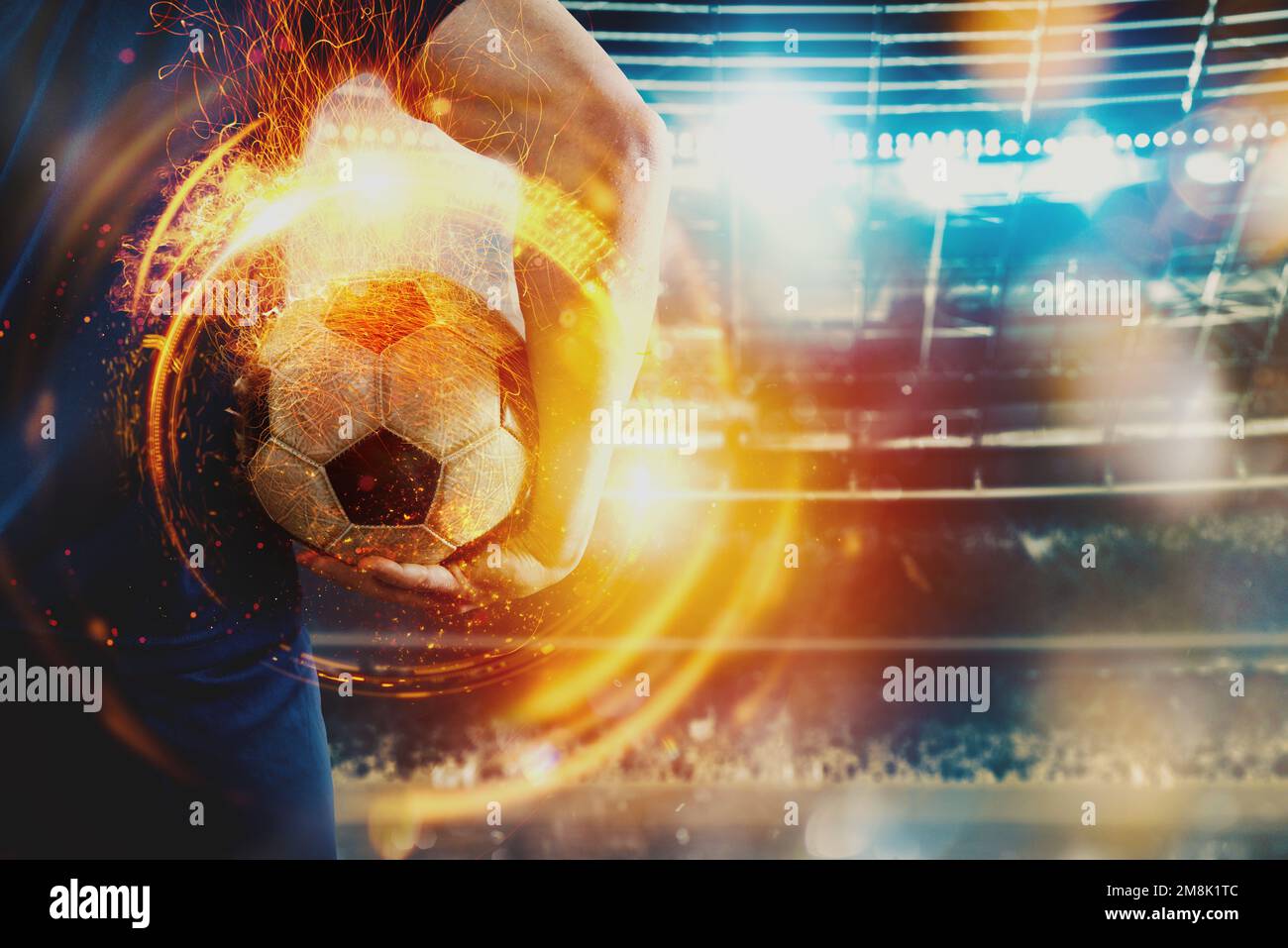 Joueur de football prêt à jouer avec le sockcerball en flamme au stade Banque D'Images