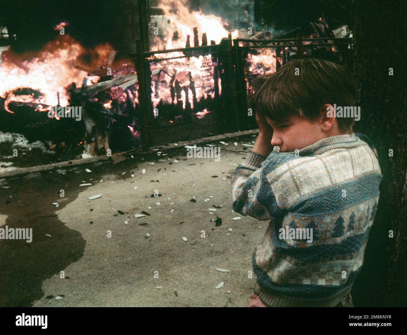 Photographe militaire de l'année gagnant 1996 titre: Catégories de brûlures: Prix du directeur; nouvelles; Portfolio place: Troisième place dans les nouvelles brève Description: Un jeune tourne la tête de la chaleur comme il est témoin des incendies causés par les bombes. Date exacte prise de vue inconnue. Pays : inconnu Banque D'Images