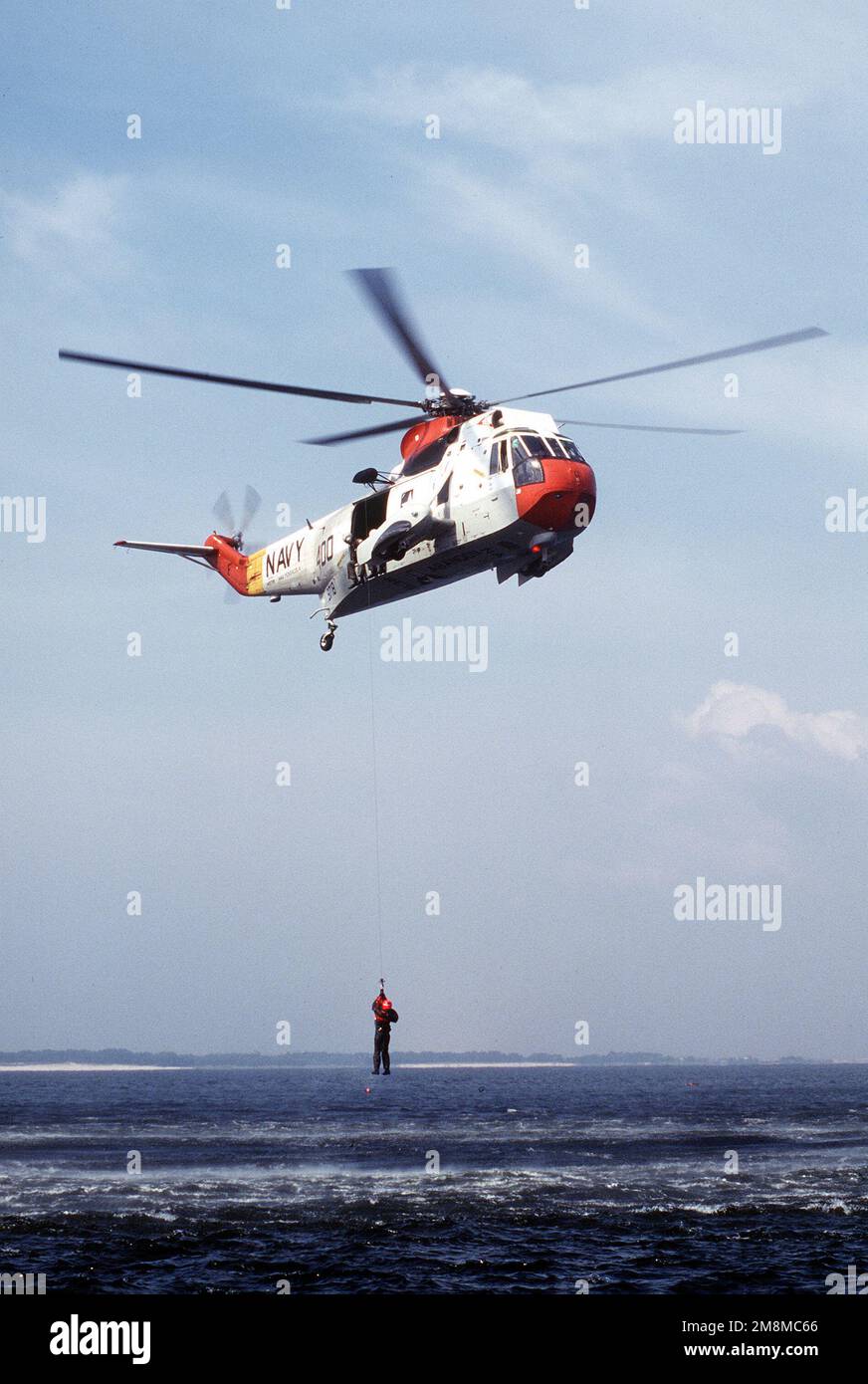 Un étudiant à la base aérienne navale de Pensacola, le cours d'entraînement de survie en eau du joint Service de Floride, est hissé à bord d'un hélicoptère de la Marine, après avoir utilisé avec succès un signal de main pour son « signal » du surf. Le 17th e Escadron d'entraînement de la Force aérienne travaille avec le personnel de la Marine à l'entraînement des membres d'équipage des deux services sur les techniques de survie en eau à la station navale de Floride.publié dans AIRMAN Magazine, décembre 1996. Date exacte prise de vue inconnue. Base: Naval Air Station, Pensacola État: Floride (FL) pays: Etats-Unis d'Amérique (USA) Banque D'Images