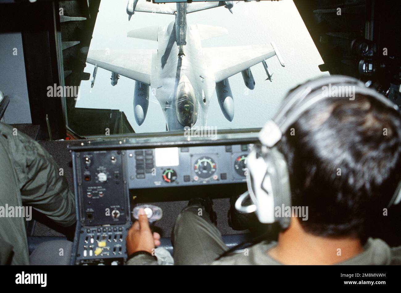 Un F-16 Falcon avec la flèche de ravitaillement fixée peut être vu par la fenêtre de l'opérateur de la flèche d'un KC-10. SGT MAÎTRE Robert Morales, 709th Escadron de ravitaillement en vol, est l'exploitant du boom. Le F-16 revient d'une course à l'attentat. Sous les ailes (de gauche à droite) se trouve un module ami pour l'entraînement, un rack SUE, deux réservoirs de carburant, un rack TUR et un missile SIDEWINDER AIM-9. Objet opération/série: JOINT TASK FORCE 95-3 base: MCA, Cherry point État: Caroline du Nord (NC) pays: États-Unis d'Amérique (USA) Banque D'Images