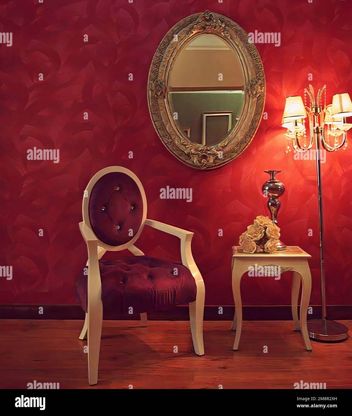 Cette chambre en parquet est dotée d''un fauteuil contre un mur rouge et d''un miroir, de lampes et d''une petite table Banque D'Images