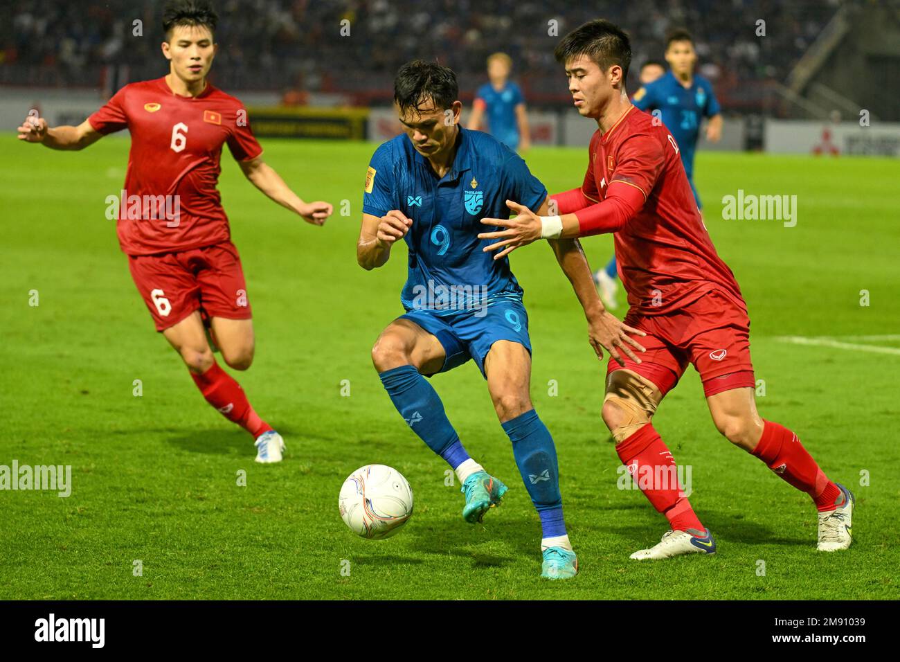Vietnam's Nguyen Thanh Binh, left, Thailand's Adisak Kraisorn, center, and  Vietnam's Do Duy Manh fight for the ball during their second leg of the  ASEAN Football Federation (AFF) Cup final soccer match