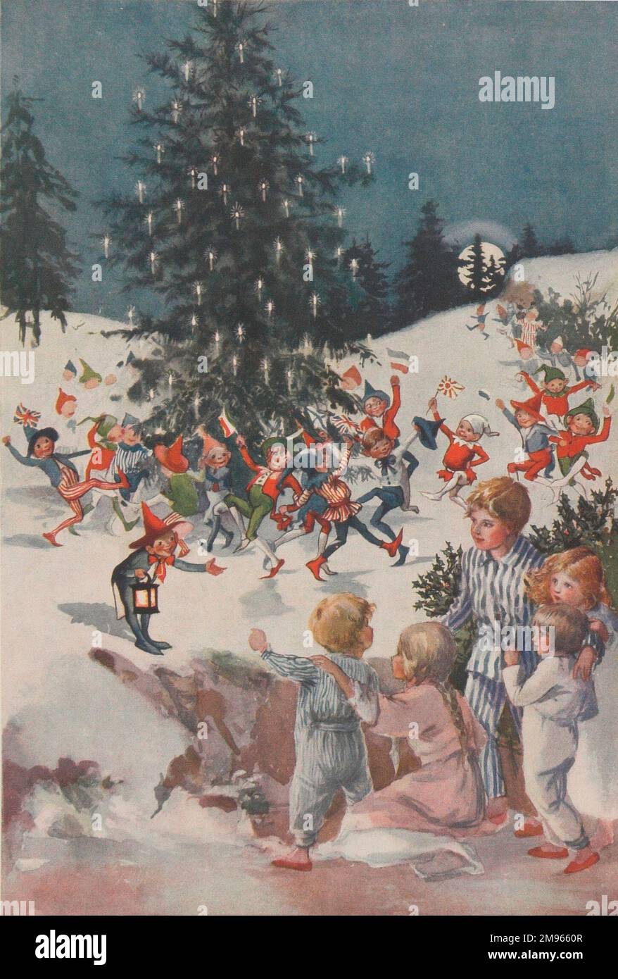 Une scène de Noël festive avec un groupe d'enfants dans leurs vêtements de nuit invités à danser autour d'un arbre de Noël. Banque D'Images