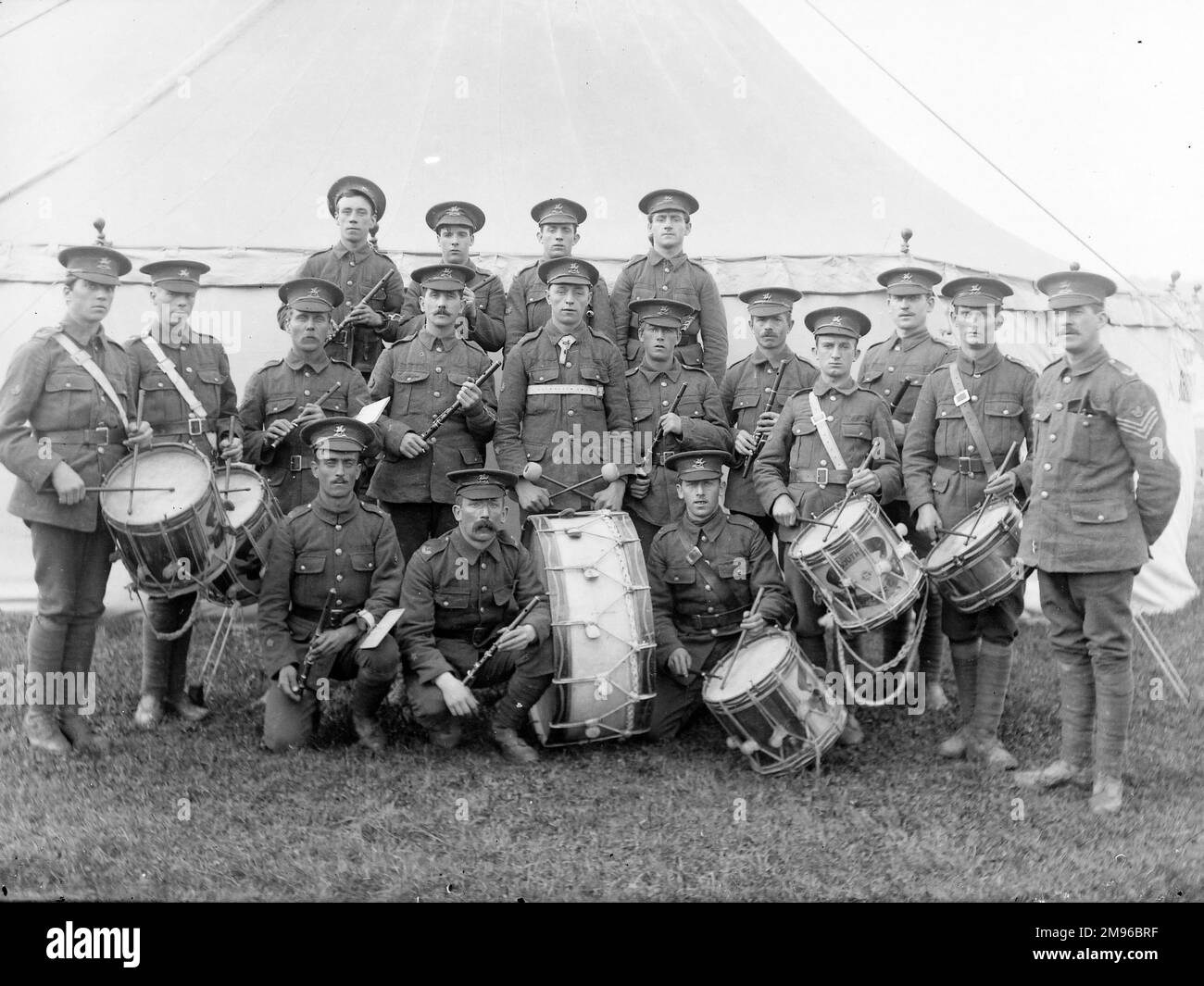 Un groupe militaire, le Brecknockshire Battalion South Wales Borderers, avec leurs instruments, dont six tambours, posant pour leur photo devant une tente. Banque D'Images