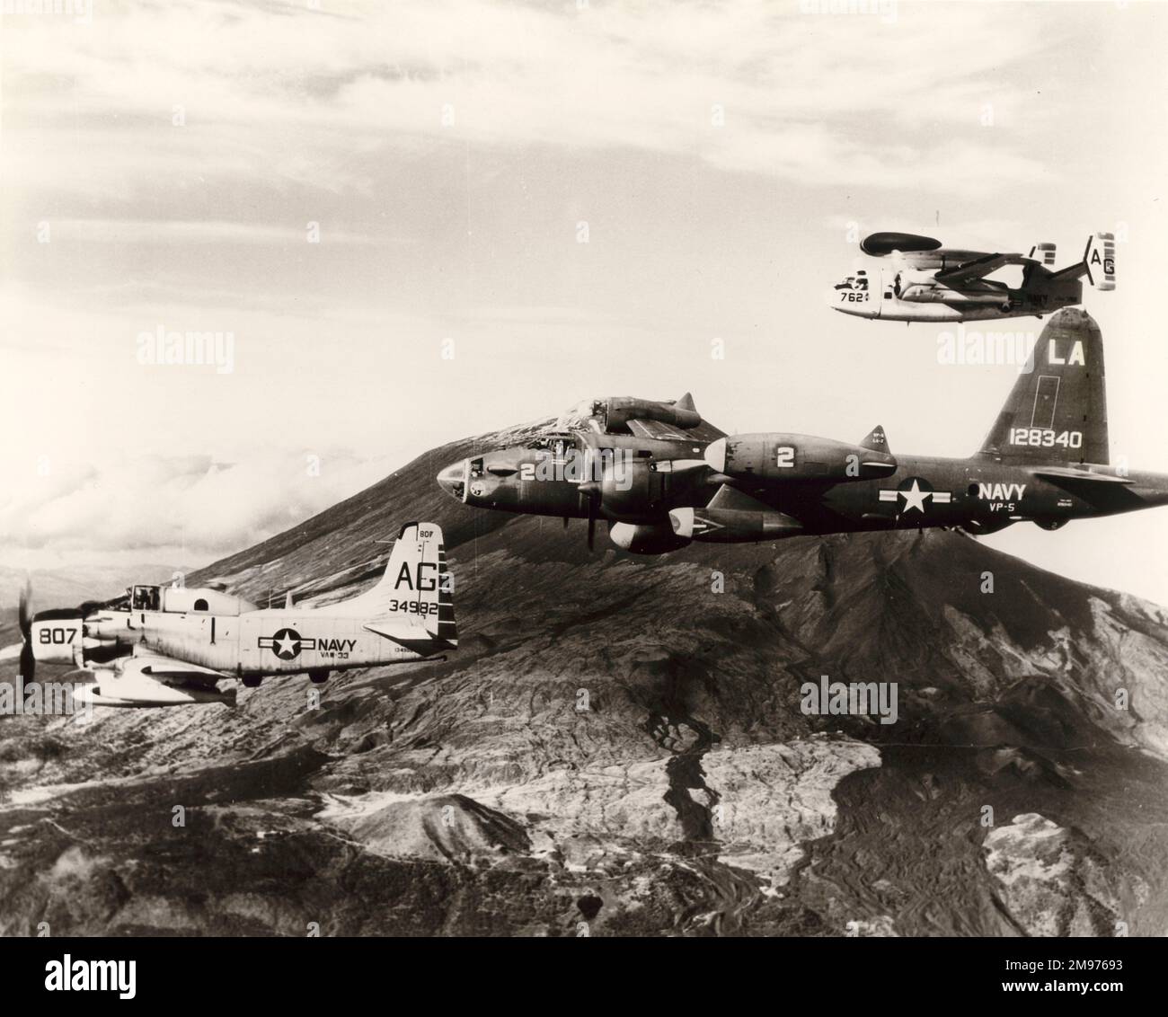 De gauche à droite: Douglas AD-1 Skyraider, 134982; Lockheed P2V-5 Neptune, 128340, et un Grumman WF-2 de l'installation navale aérienne de Sigonella, Sicile, en formation près de l'Etna. Banque D'Images