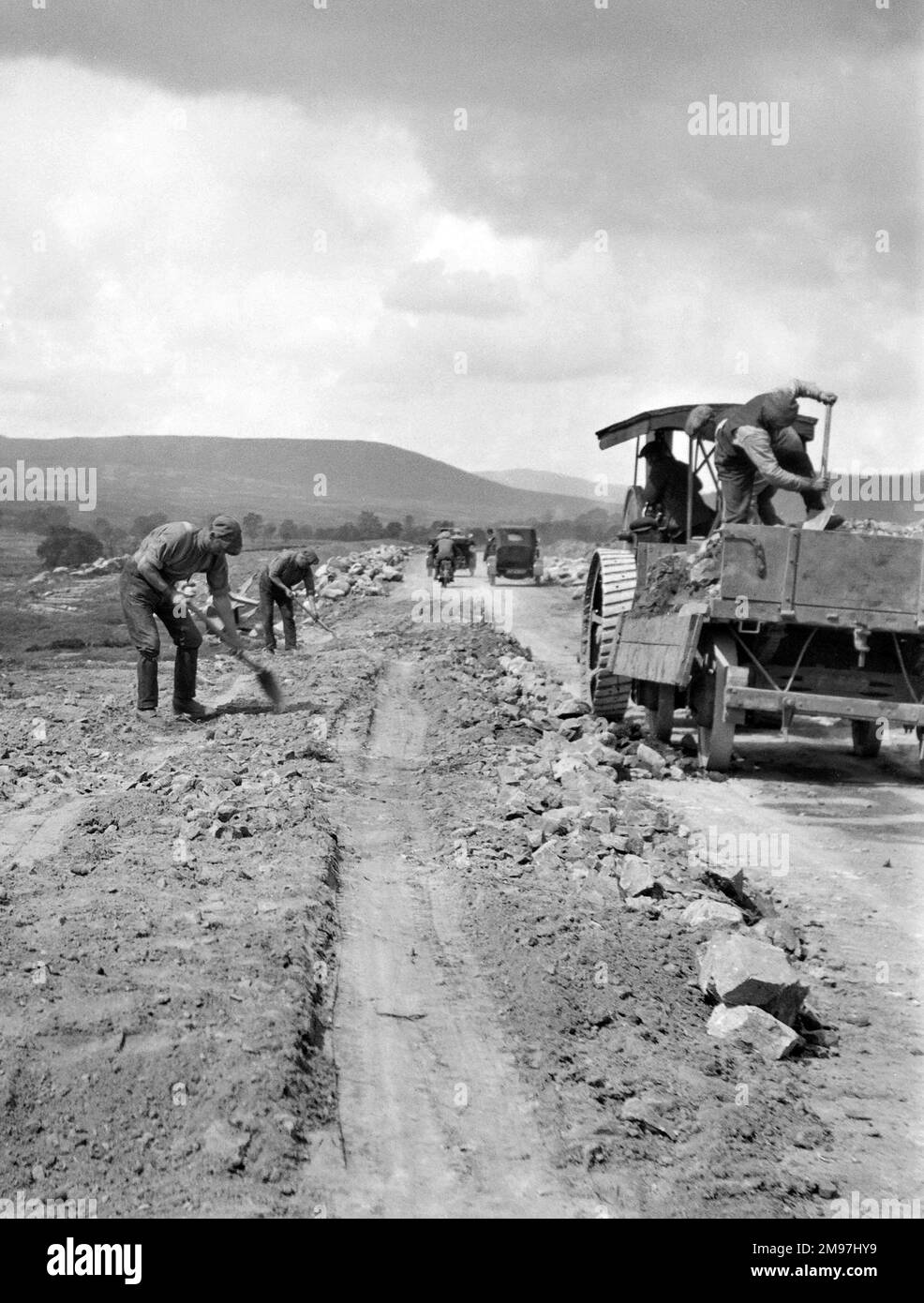 Hommes engagés dans des travaux routiers avec un camion à côté. Banque D'Images