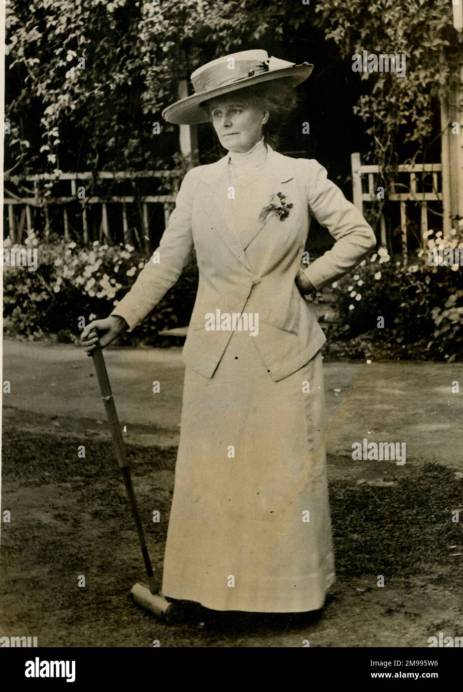 Femme se reposant pendant une partie de croquet. Banque D'Images