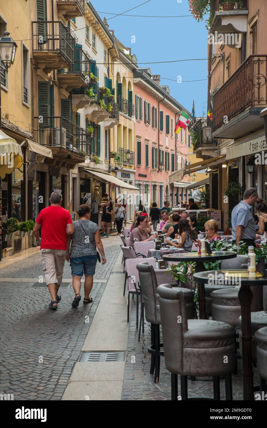 Les touristes se promenant et prenant le café du matin dans les cafés de la rue à Peschiera, le lac de Garde, le nord de l'Italie Banque D'Images
